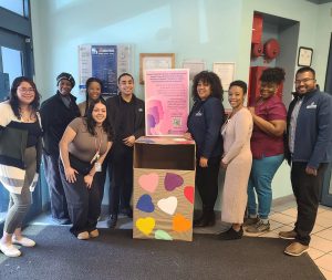 The Jamaica Hospital Medical Center team standing with a donation collection box for Food Bank NYC's Woman to Woman initiative.